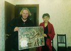 Alexey Akindinov and director of the Beijing Art Gallery - Ms. Ming with the painting \"Blacksmith\" Akindinov. September 5, 2017. Moscow.