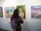 A spectator at Alexei Akindinov\'s painting \"The Rose Fairy\". International exhibition-competition \"World of Esotericism\", gallery \"Art-Commune\", Moscow, st. Kyiv, 2. Opening of the festival 04/15/2023.