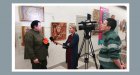 Alexey Akindinov gives an interview to television. At the opening of his personal exhibition \"Ornamental Reality\". Art Gallery \"Prio-Vneshtorgbank\", Ryazan. 02/20/2023.