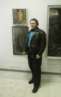 The artist – Alexey Akindinov against the picture \"My Grandfather Vasily\" (from above) and Alexander Okonechnikov\'s pictures. The Spring 2015 exhibition devoted to the 70 anniversary of the Victory over fascism.